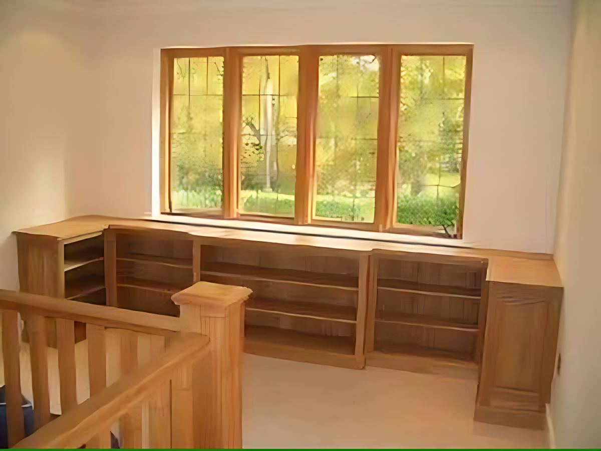 A bookshelf fitted under a window in Horsham by Adam Harman